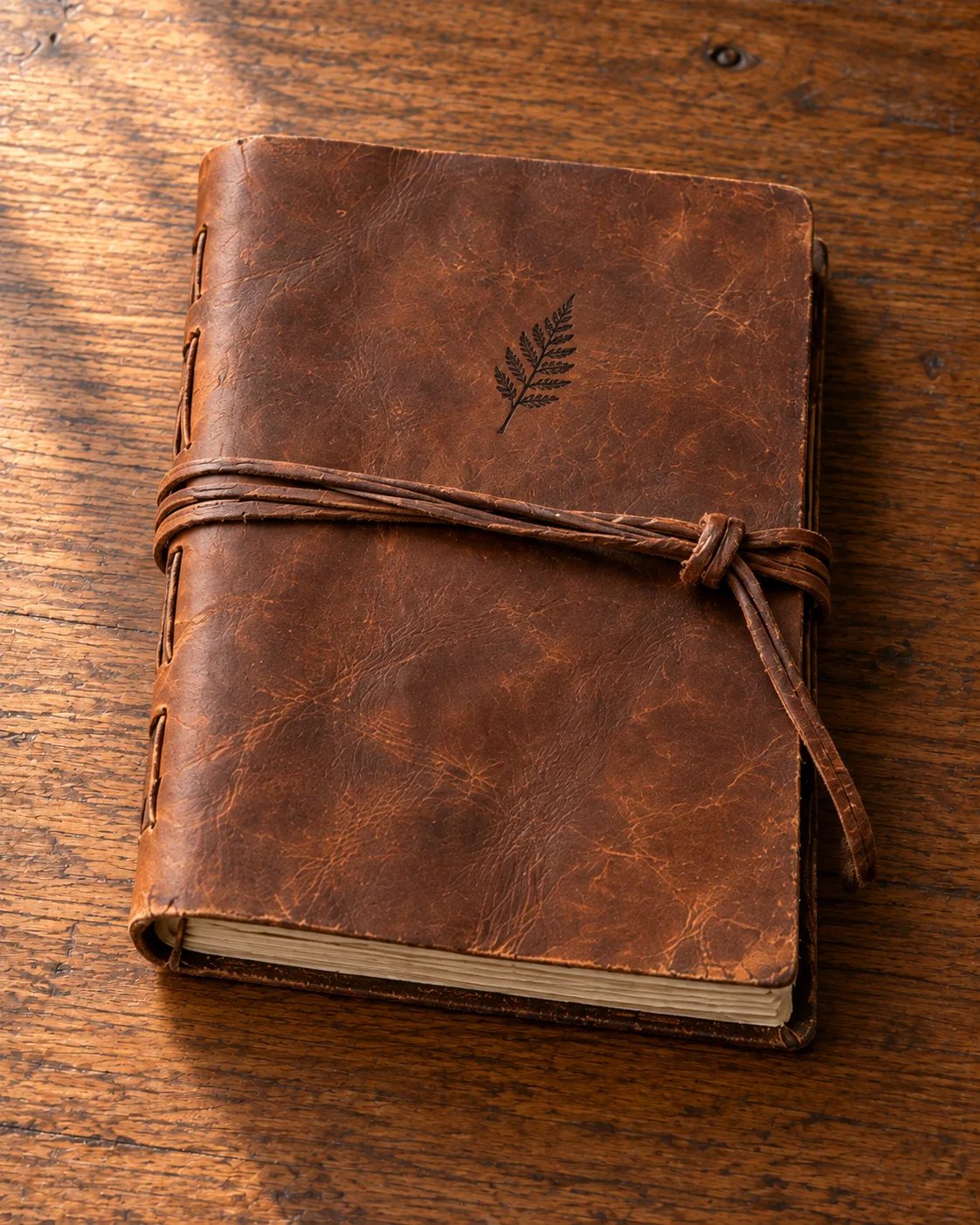 A leather-wrapped grimoire tied with a cord